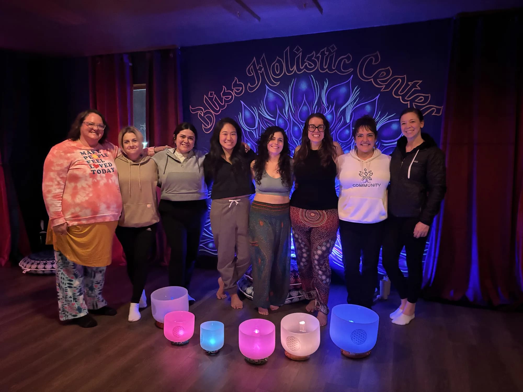 A group of participants smiling together after a sound bath at Bliss Holistic Center