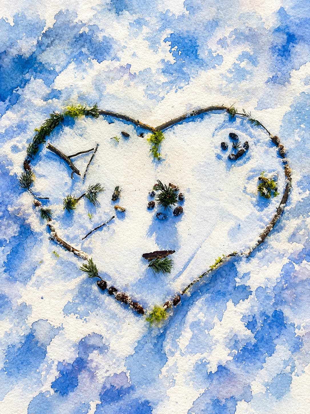 A heart made from twigs and pinecones in the snow